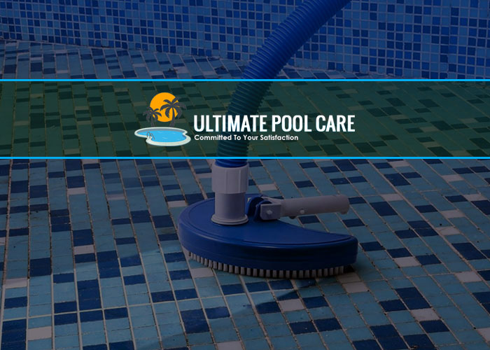 pool-vacuum-cleaning-pool-floor-with-blue-and-white-tiles