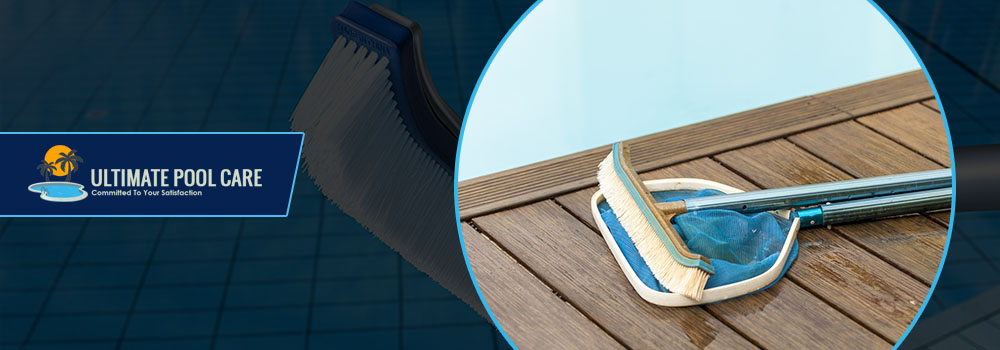 pool-brush-and-skimmer-on-wooden-pool-deck